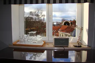a window with a table with glasses and a lamp at German18-3B Luxury Vilnius apartment in Vilnius