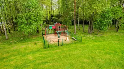 a playground in the middle of a field with trees at Ramybes Uostas in Švedriškė