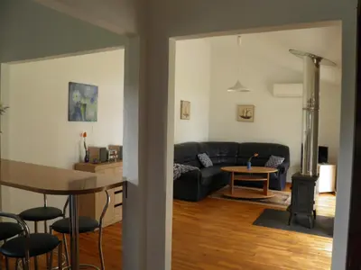 a living room with a couch and a table at Ramybes Uostas in Švedriškė