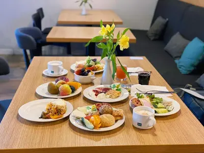 a wooden table with plates of food on it at UPA Medical SPA in Druskininkai