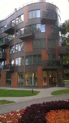 a large building with a lot of windows at Saulės Sonata Etude in Druskininkai