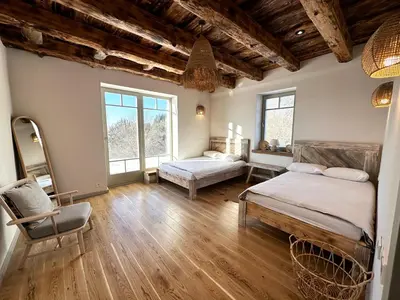 a room with two beds and a chair in it at Dabintos slėnis in Sumiliszki