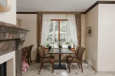 a dining room with a table and chairs and a window at Pušynė in Birštonas