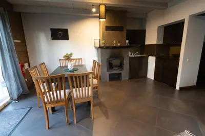 a kitchen and dining room with a table and chairs at Sodybos kompleksas - ECO Resort Trakai in Antakalnis