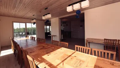 a large wooden table and chairs in a room at Sodybos kompleksas - ECO Resort Trakai in Antakalnis