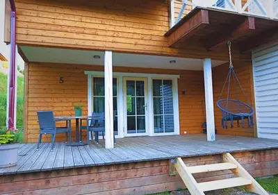 a porch of a house with a table and chairs at Sodybos kompleksas - ECO Resort Trakai in Antakalnis