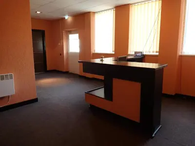an office with a desk in an orange room at Sveciu Namai- Kazlu Ruda in Kazlų Rūda