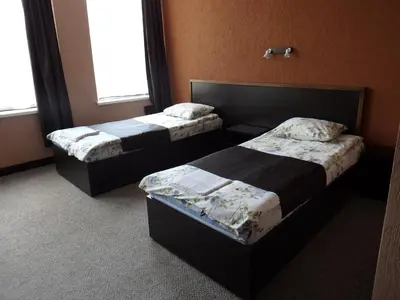 two beds in a hotel room with two bedsitures at Sveciu Namai- Kazlu Ruda in Kazlų Rūda