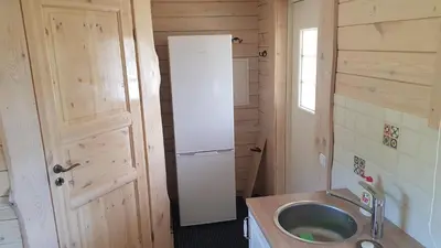 a small kitchen with a sink and a refrigerator at Vienkiemis prie Merkinės in Merkinė
