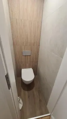 a small bathroom with a toilet in a stall at Cozy Center Apartment in Druskininkai in Druskininkai