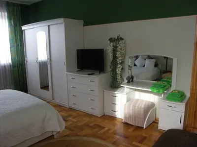 a bedroom with a bed and a mirror at Home for Guests Lakštingala in Šiauliai