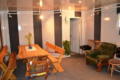 a room with a table and chairs and a table and a chair at Home for Guests Lakštingala in Šiauliai