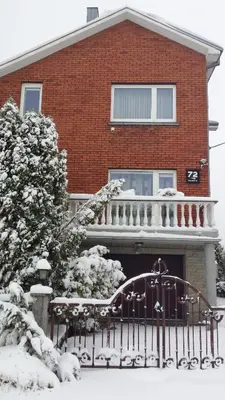 a house with a fence in the snow at Home for Guests Lakštingala in Šiauliai