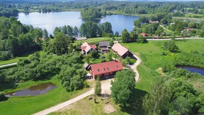 an aerial view of a house with a lake at Sunny Beaver B&B in Trakai