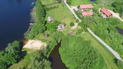 an aerial view of a house on an island in a river at Sunny Beaver B&B in Trakai