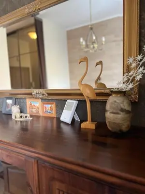 two wooden birds sitting on top of a wooden table at Apartment Vilnius Old Town in Vilnius