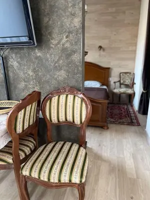 a room with a chair and a bedroom with a bed at Apartment Vilnius Old Town in Vilnius