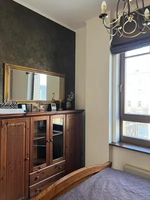 a bathroom with a mirror and a wooden dresser at Apartment Vilnius Old Town in Vilnius