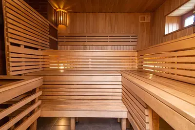 a sauna with wooden walls and wooden benches at Anupro Villa in Trakai