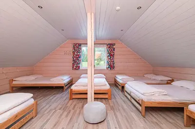 a room with four beds and a window at Anupro Villa in Trakai