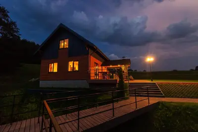 a house with the lights on at night at Anupro Villa in Trakai