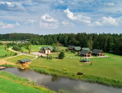 an aerial view of a resort with a river at Harmony Park Countryside Villas & SPA in Prienai