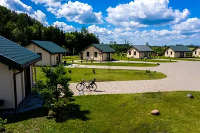 a bike parked in front of a row of houses at Harmony Park Countryside Villas & SPA in Prienai