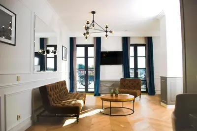 a living room with two chairs and a table at Vytautas Mineral SPA in Birštonas