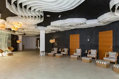 a lobby with chairs and tables and a ceiling with clouds at Vytautas Mineral SPA in Birštonas