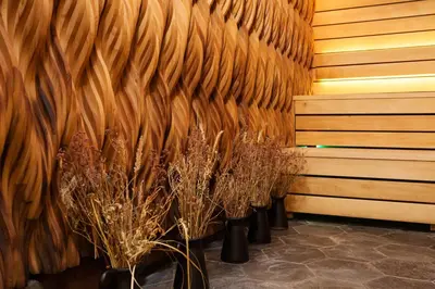 a row of potted plants in a room with a wall at Vytautas Mineral SPA in Birštonas