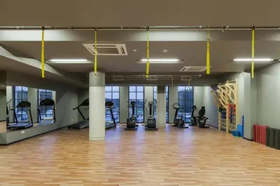 a gym with treadmills and elliptical machines at Vytautas Mineral SPA in Birštonas