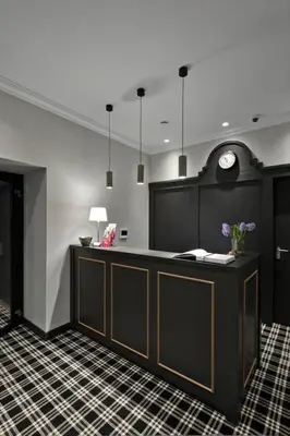 a lobby with a counter with a clock on the wall at 15th Avenue in Vilnius