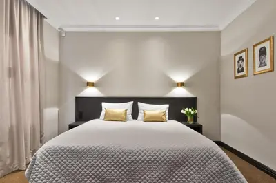 a bedroom with a large bed with two yellow pillows at 15th Avenue in Vilnius
