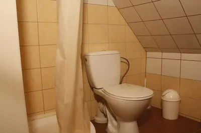 a bathroom with a toilet in a small room at The Jolly Man in Vilnius