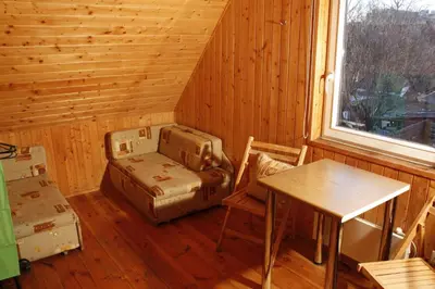 a cabin with a table and a chair and a table and a window at The Jolly Man in Vilnius