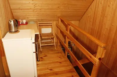 a small kitchen with a refrigerator in a cabin at The Jolly Man in Vilnius