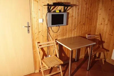a room with a table and a tv on a wall at The Jolly Man in Vilnius