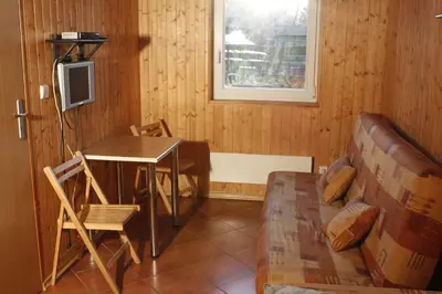 a living room with a table and a couch at The Jolly Man in Vilnius