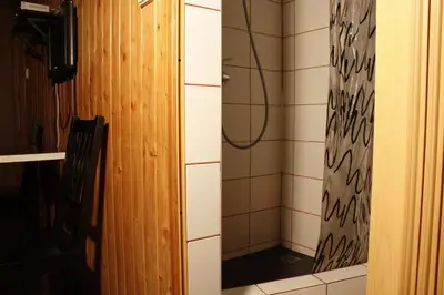 a shower with a mirror in a bathroom at The Jolly Man in Vilnius