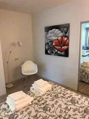 a room with a mirror and a pile of towels at Apartamentai Fortuna in Kaunas