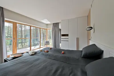 a bedroom with a large bed with fruit on it at Ami Residence Forest in Didžiasalis