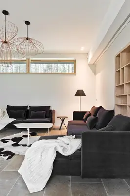 a living room with two couches and a table at Ami Residence Forest in Didžiasalis