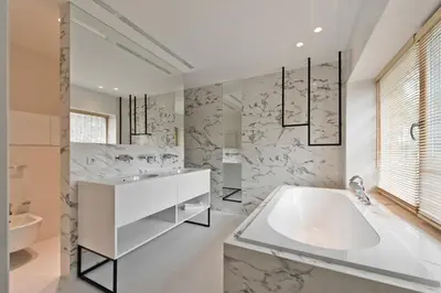 a white bathroom with a tub and a sink at Ami Residence Forest in Didžiasalis