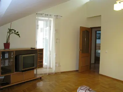 a living room with a tv and a window at Pilies Street Sanctuary Secure Old Town Apartmen in Vilnius