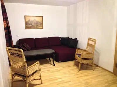 a living room with a couch and two chairs at Pilies Street Sanctuary Secure Old Town Apartmen in Vilnius