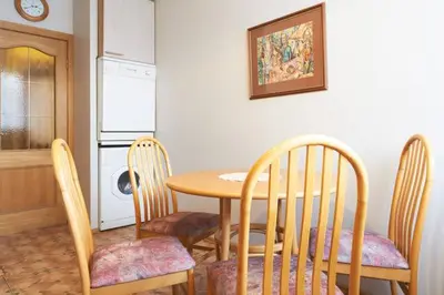 a kitchen with a table and three chairs and a table and a microwave at Pilies Street Sanctuary Secure Old Town Apartmen in Vilnius