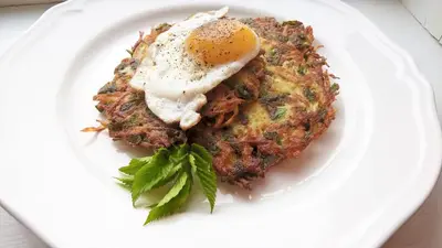 a plate of food with an egg on top at Labanoras in Labanoras