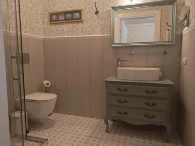 a bathroom with a sink and a toilet and a mirror at Labanoras in Labanoras