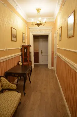 a hallway with a table and chairs in a room at Gabi B&B in Vilnius