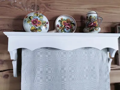 a white table with three vases on it at Trainiškio pirkia in Ginučiai